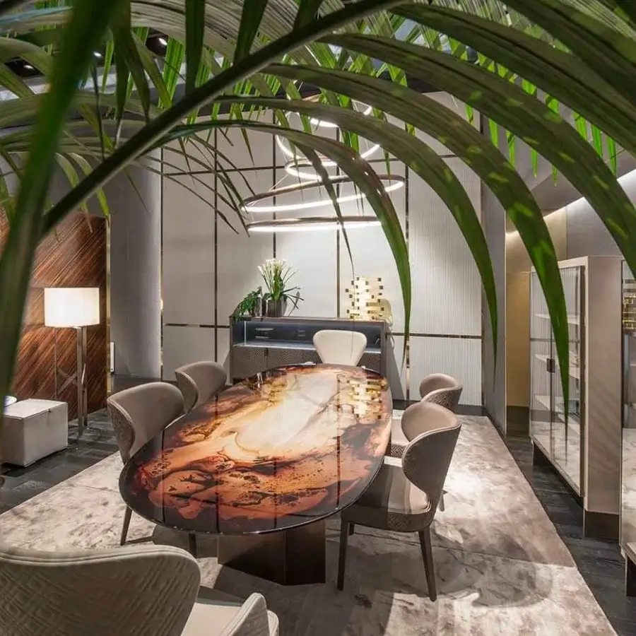 Lavish Rugiano Pedro table with swirling abstract tabletop resembling stone and glossy finish built with bronzed brass base
