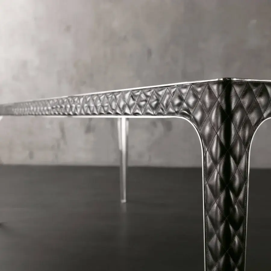 Exclusive Rugiano Alexander table with quilted black leather and white trim, accented with bronzed brass or chrome details