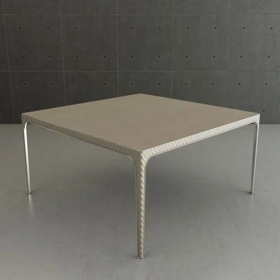 Exceptional Rugiano Alexander table with light beige leather and slender rounded metal legs exhibiting bronzed brass details