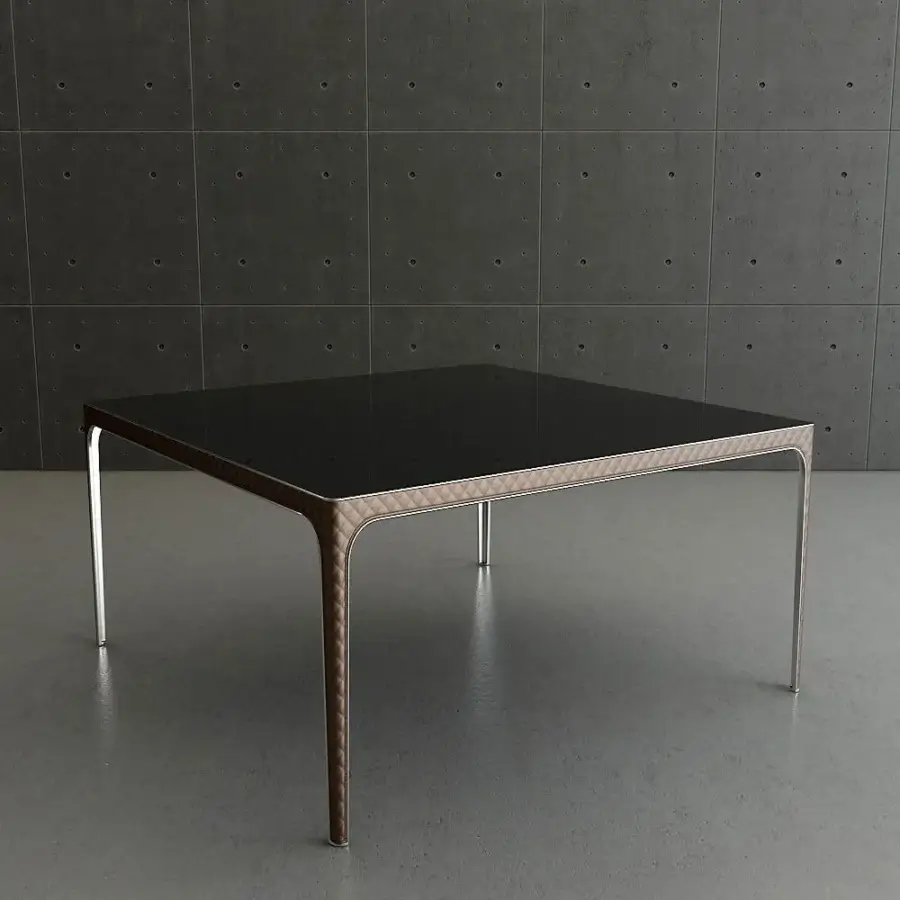 Lavish Rugiano Alexander table with a sleek glass top and quilted light brown material with bronzed brass accents