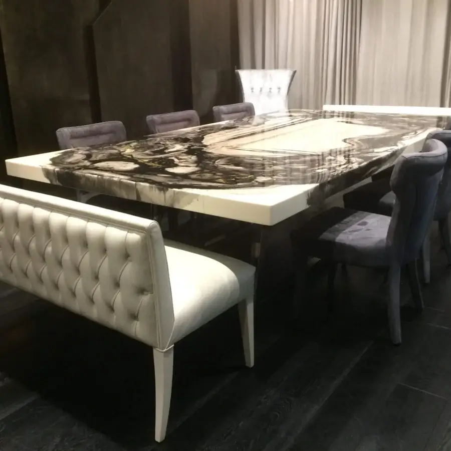 Lavish Rugiano Decoro table built with decoro painted wood in black and white with a gleaming metallic base and gray upholstered chairs plus a white tufted bench