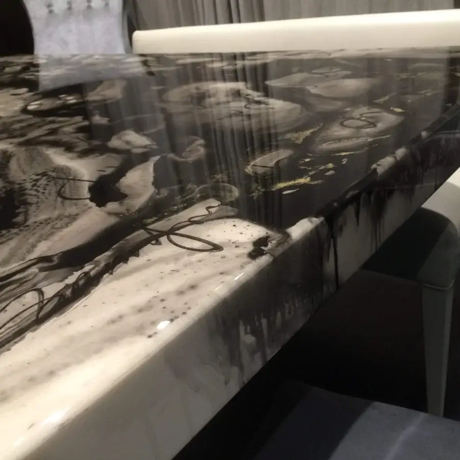 Superior Rugiano Decoro table with decoro painted wood exhibiting swirling black, white and gold abstract marble effect and glossy sheen