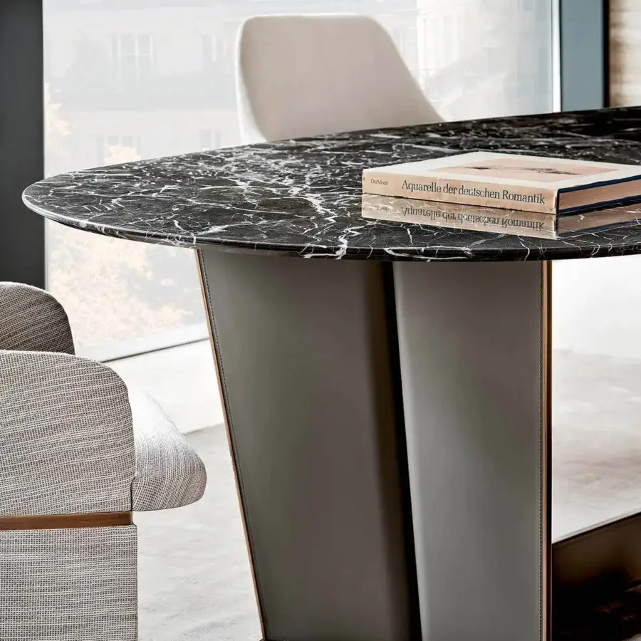 Distinguished Rugiano Wings table crafted in Italy with black and white marble-like top and bronzed brass-finished leather-like base