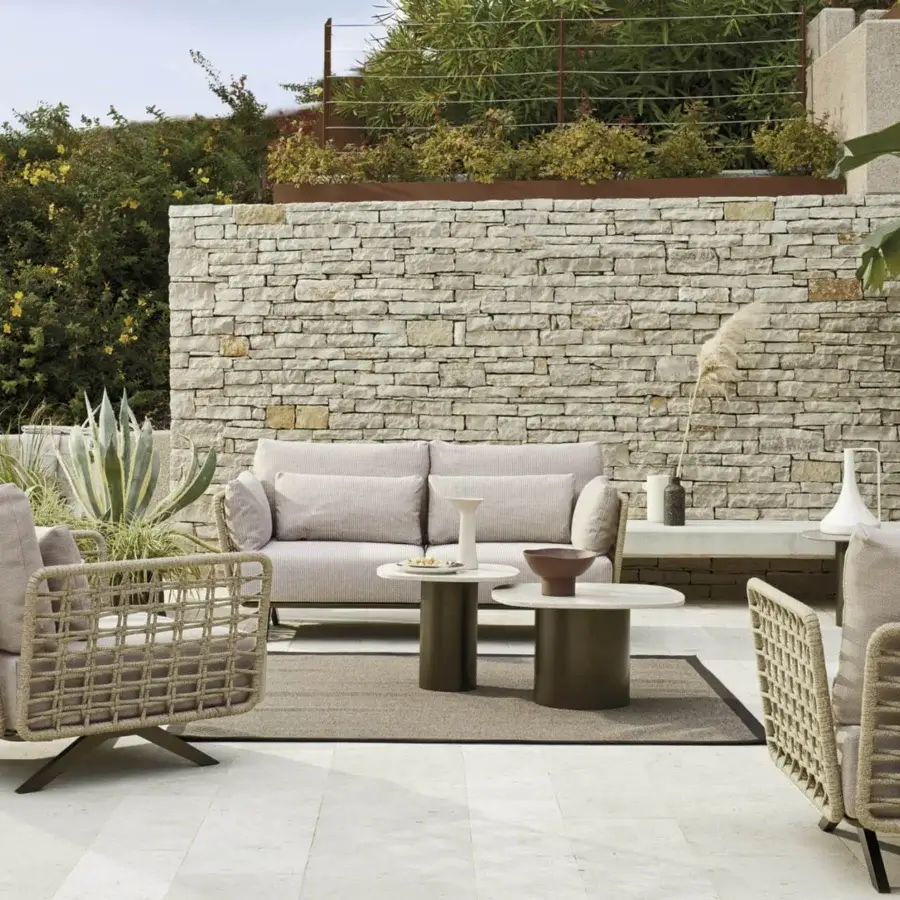 Distinguished Roberti Rànan sofa crafted with stainless steel and aluminum, woven in Oval Trendyrope with light beige cushions