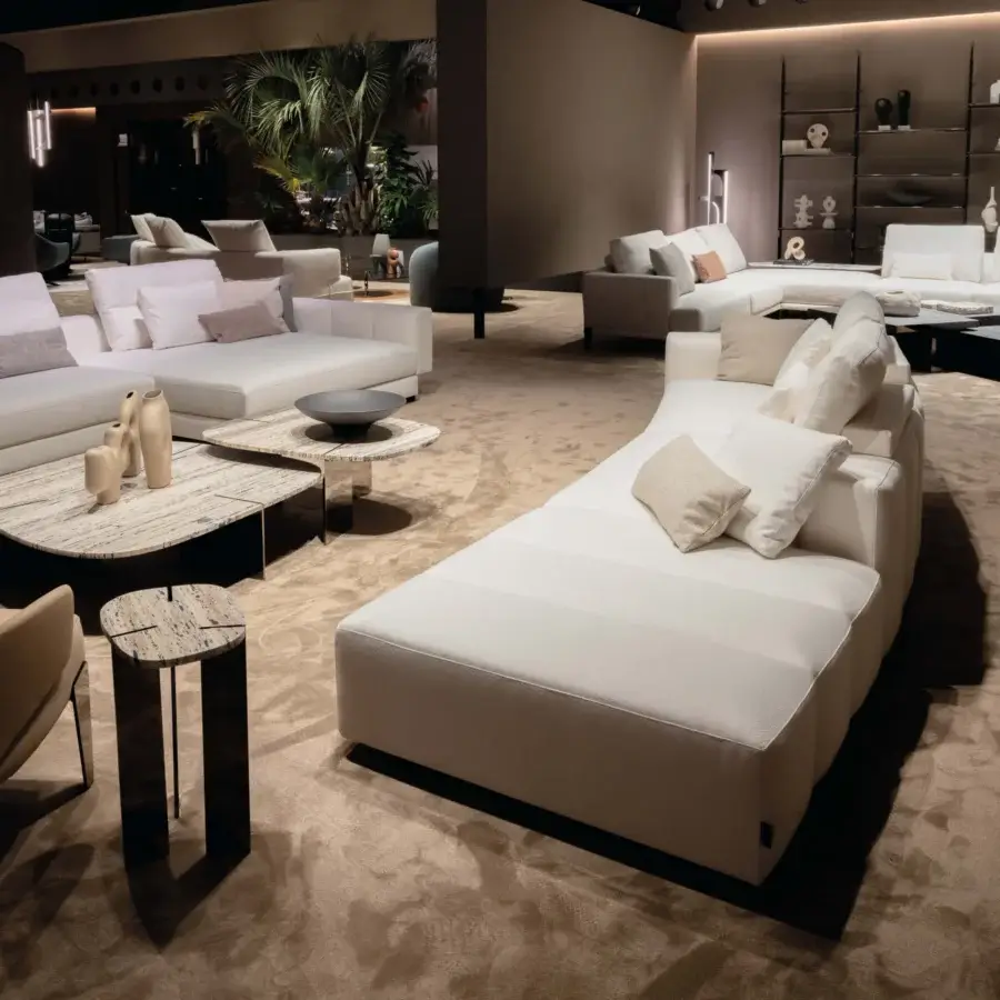 Captivating Arketipo Milky Way sofa with a low curved silhouette upholstered in textured light cream textiles and rounded cushions