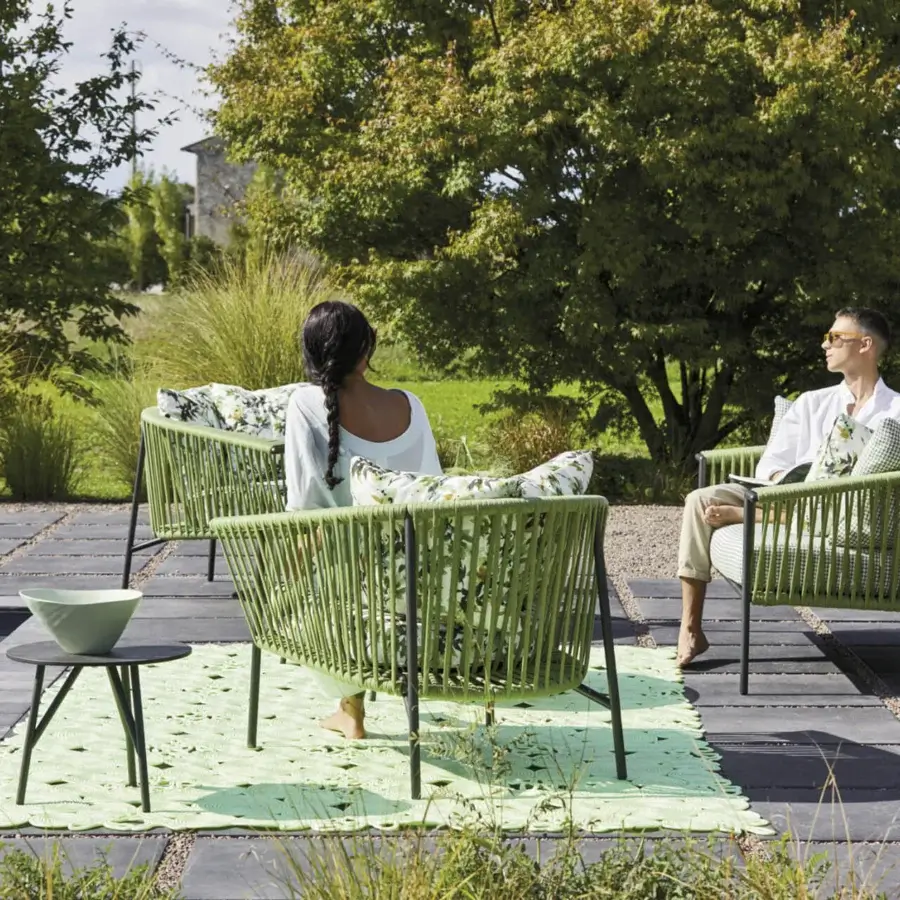 Elegant Roberti Rattan Corolle lounge chair with green woven Oval Trendyrope and black powder coated Aisi 304 stainless steel legs