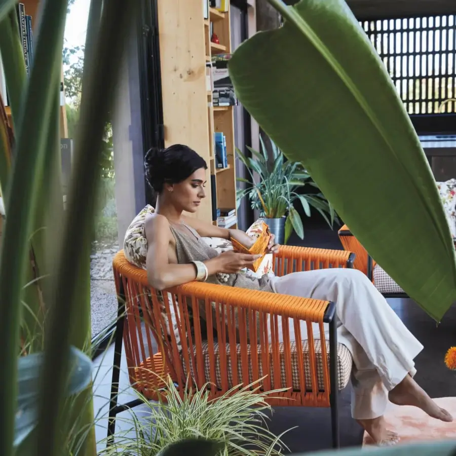 Distinguished Roberti Rattan Corolle lounge chair woven with orange Oval Trendyrope and black Aisi 304 stainless steel frame