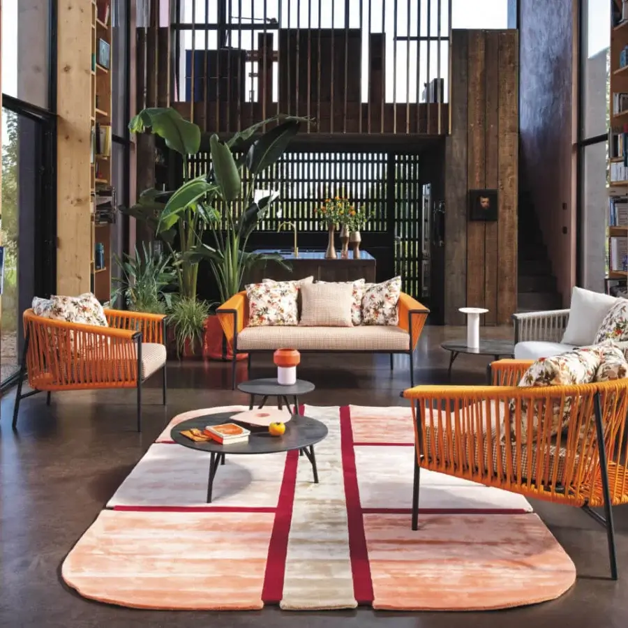 Elegant Roberti Rattan Corolle lounge chair with vibrant orange woven Oval Trendyrope and powder-coated Aisi 304 stainless steel frame