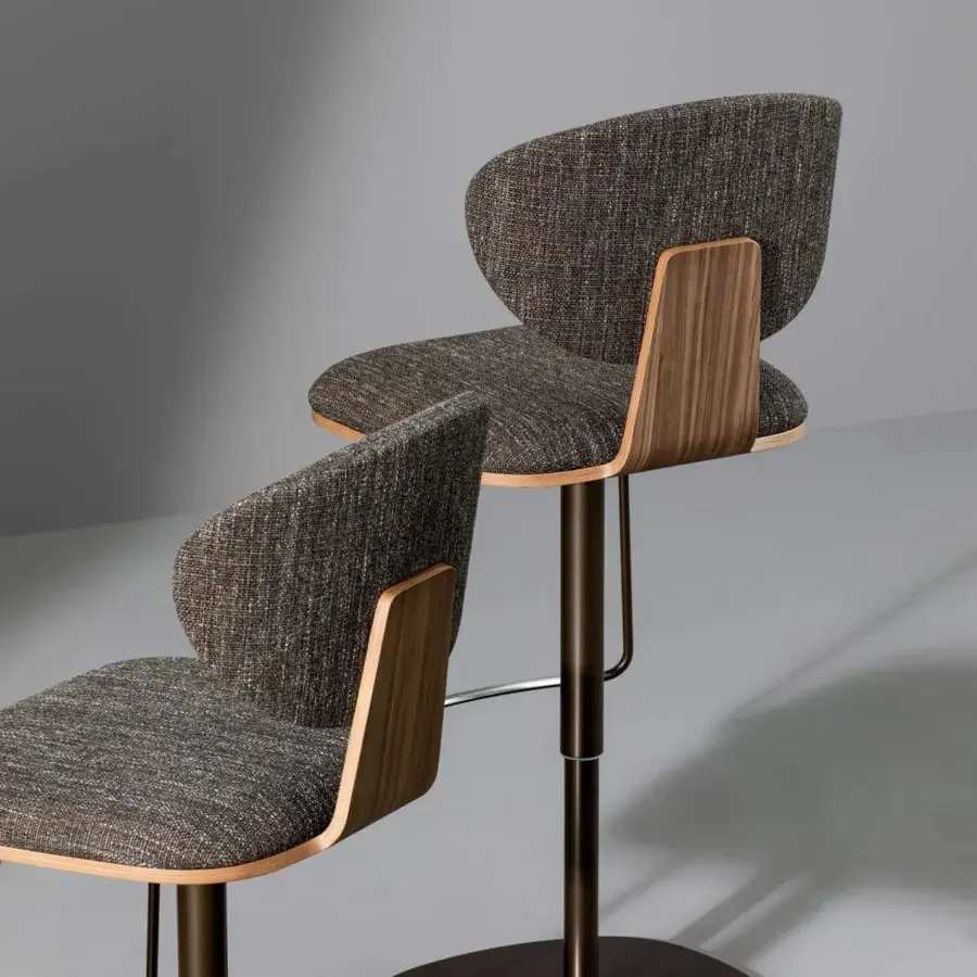 Elegant Bonaldo Olos stool with speckled brown and gray textile upholstery and curved veneered wood panel with smooth finish