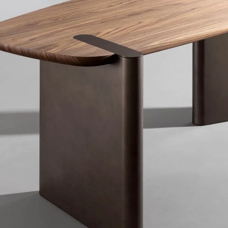 Elegant Bonaldo Flatiron desk with Canaletto walnut veneered wood and brushed bronze matt lacquered wood base exhibiting sculptural form
