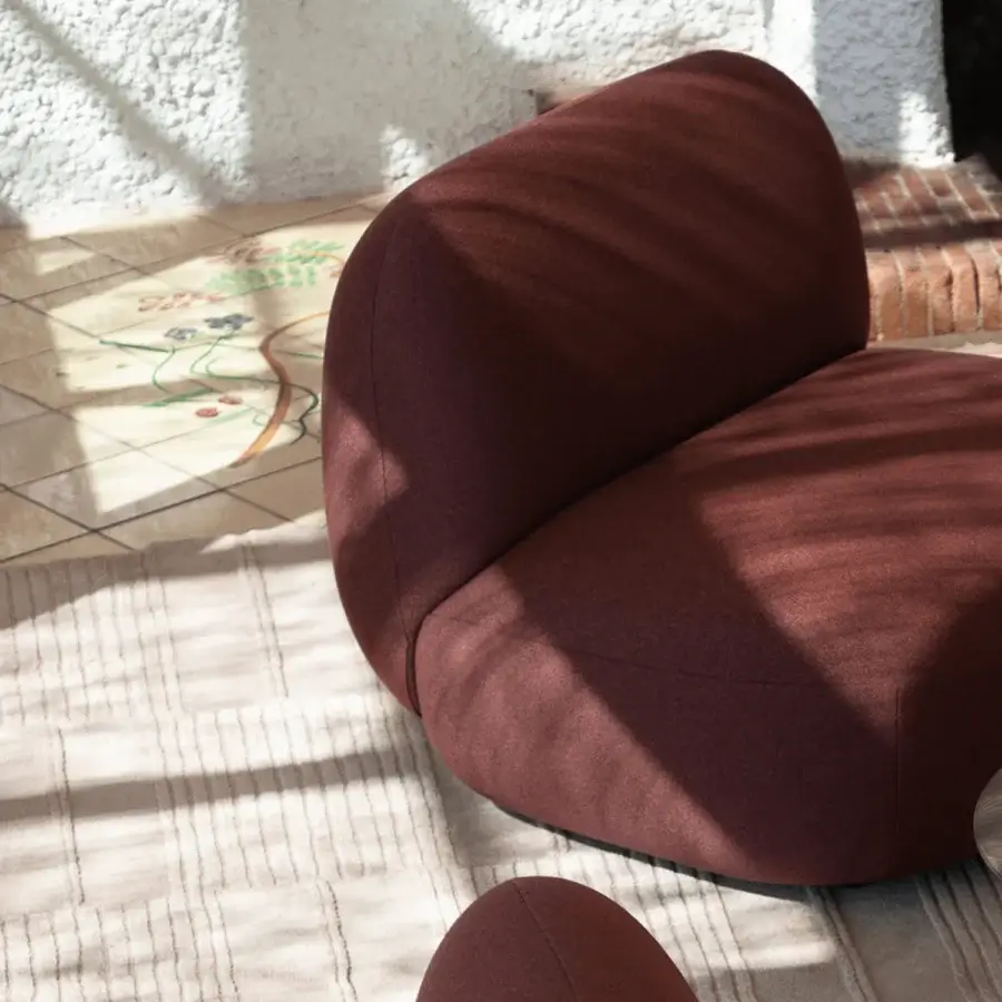 Exceptional Potocco Jade lounge chair upholstered in muted maroon textile with matte finish and organic sinuous form