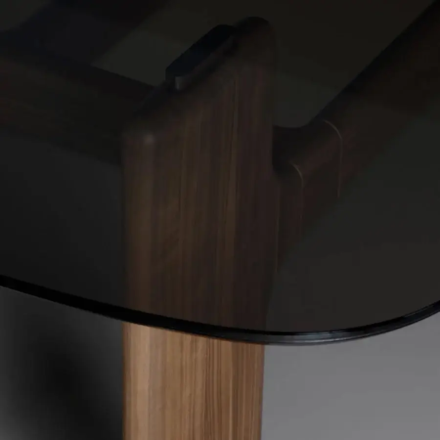 Distinguished Bonaldo Hippos table with a dark tinted glass surface and intricately curved solid wood elements