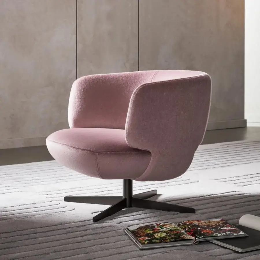 Distinctive Bonaldo Doge lounge chair with curved silhouette and dark metal base, upholstered in light pink matte textile