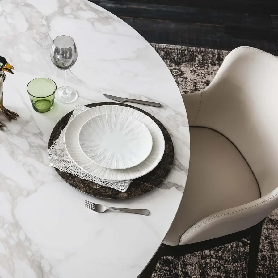Sophisticated Cattelan Italia Magda chair with enveloping curved silhouette upholstered in light beige fabric and dark matte wood base