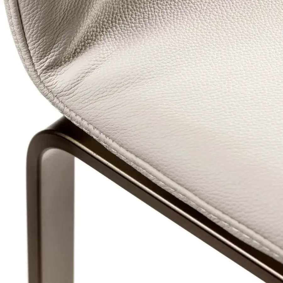 Lavish Lago Dangla chair with light textile upholstery and bronze-toned metal legs built with a robust mechanical frame