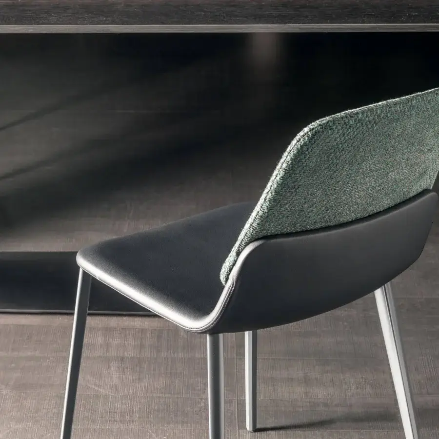 Sophisticated Lago Ermes chair with dark smooth seat and textured green grey textile backrest built with a light matte metal structure