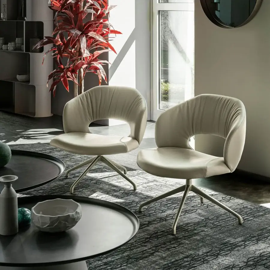 Elegant Cattelan Italia Miranda lounge chair with rounded seat and open backrest upholstered in light beige textile with matching metal finish