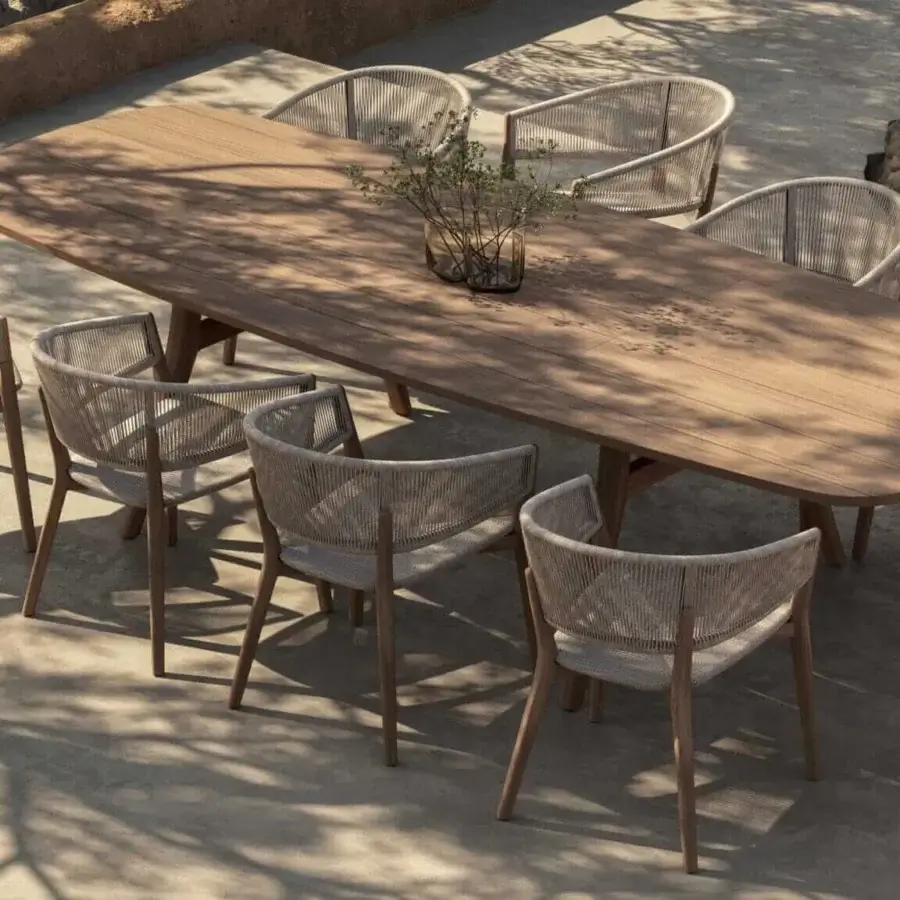 Elegant Royal Botania Zidiz dining table with teak wood frame and light beige woven seat presenting a matte finish