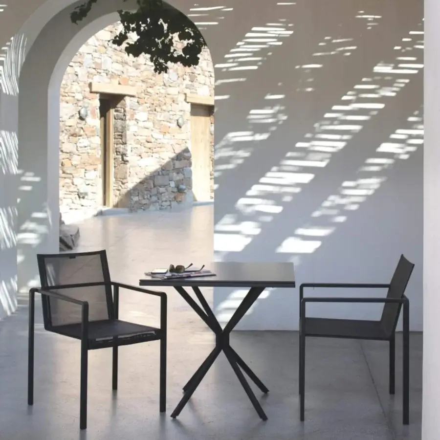 Captivating Royal Botania Alura armchair crafted with black textured aluminum and integrated armrests for contemporary spaces