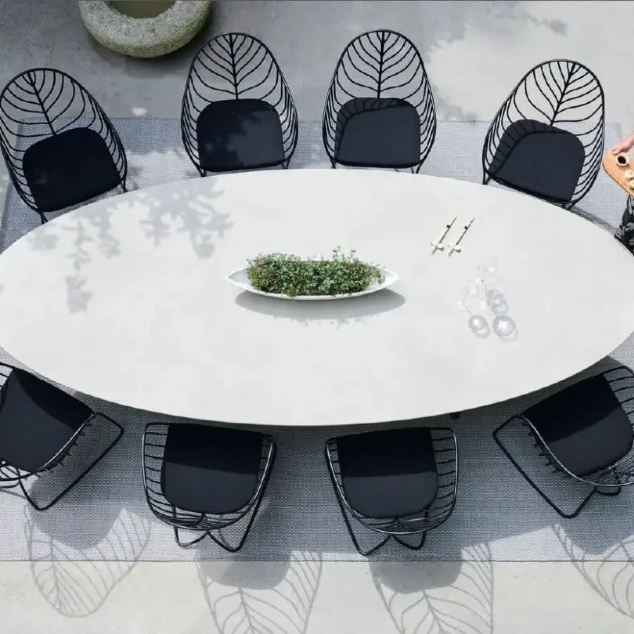 Captivating Royal Botania Folia armchair with a matte black metal frame and uniformly dark cushion embodies modern minimalist design