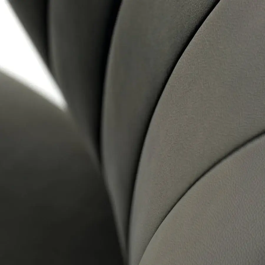 Captivating Lago Ruffle chair with quilted details and textured gray textile upholstery alongside slender legs