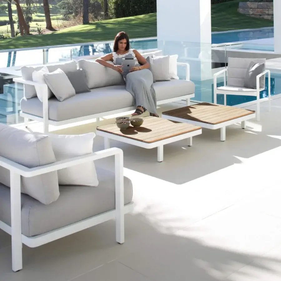 Elegant Royal Botania Alura lounge sofa with metal frame and light gray textile cushions in matte white finish