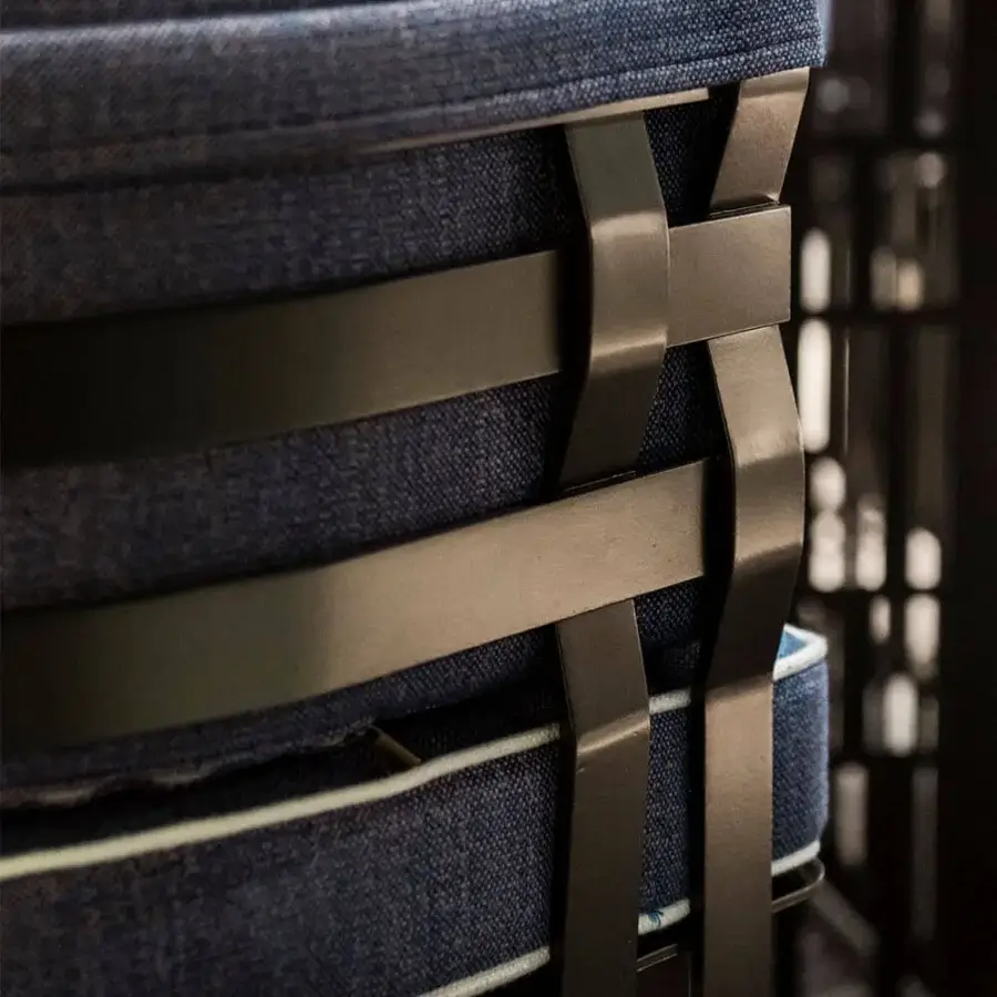 Superior Rugiano Arena armchair with dark matte metal, plush blue textured fabric cushions and light trim