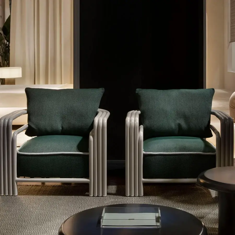 Sophisticated Rugiano Capri lounge chair with metal frame in Sand finish and plush dark green cushions