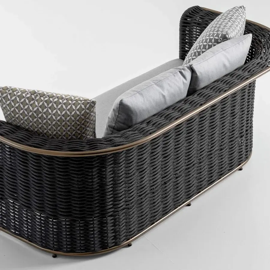 Distinguished Rugiano Marina sofa crafted with dark woven material, rope accents, bronze metal, and light patterned gray cushions