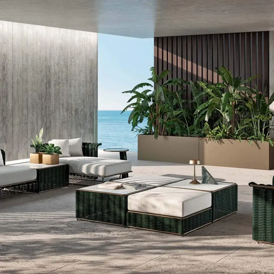 Lavish Rugiano Marina ottoman with a dark green woven foundation, light gray cushion and white stone-like surface with bronze metalwork