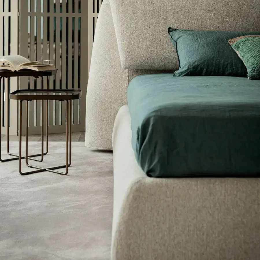 Superior Cattelan Italia Simon bed with curving headboard and lush green bedding in textured light beige fabric