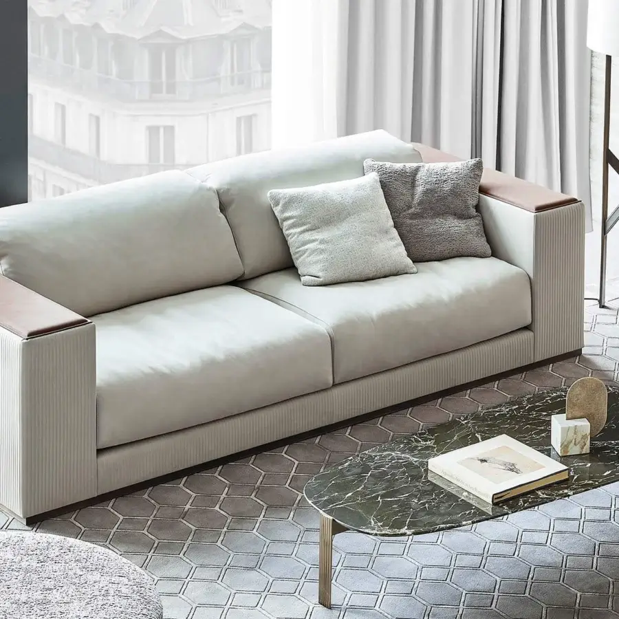 Exceptional Rugiano Vogue sofa presents a geometric silhouette upholstered in neutral textile with tan leather armrests and steel finish