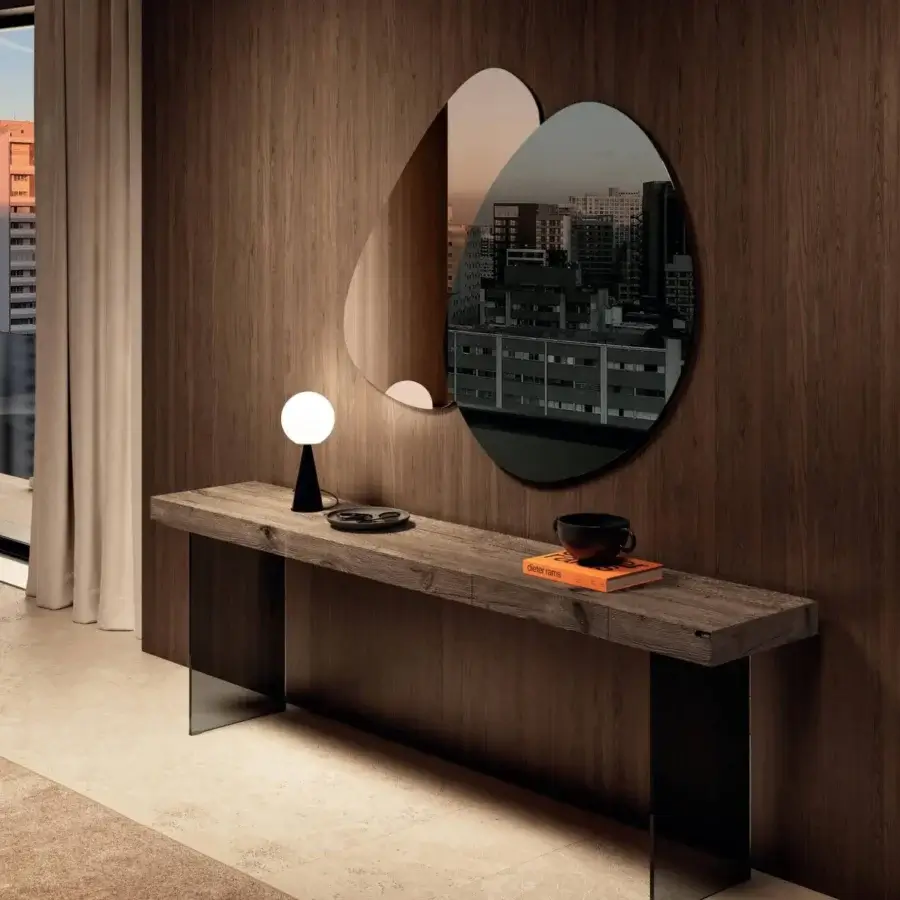 Elegant Lago Melty mirror with overlapping organic silhouettes reflecting images in neutral tones and a dusky cityscape