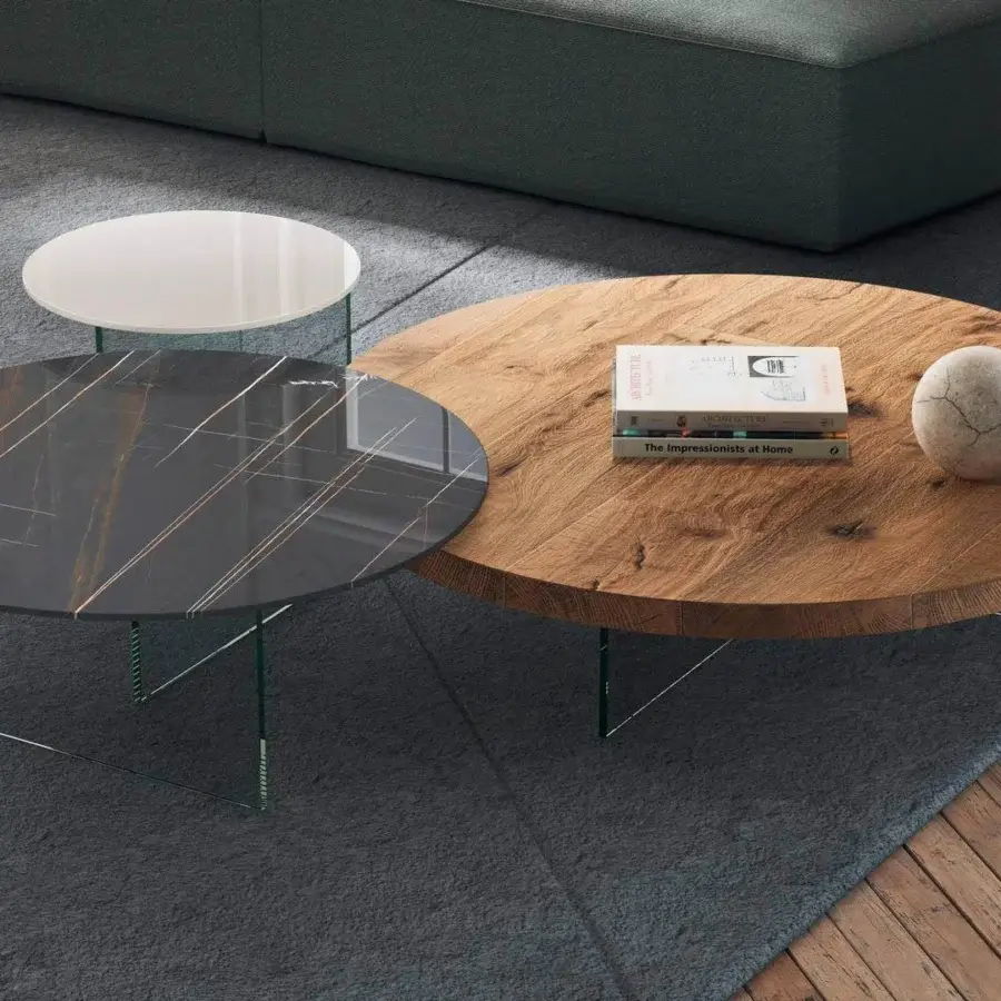 Distinguished Lago Air Round coffee table crafted in wood with a visible grain and matte finish supported by tempered glass legs