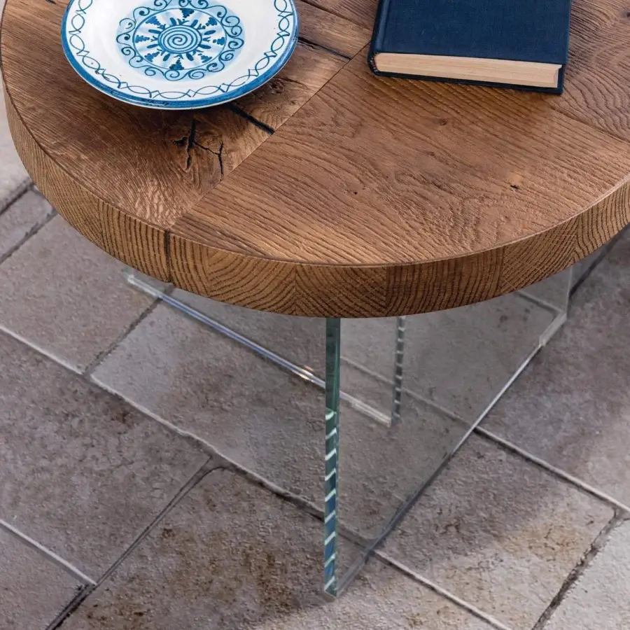 Exceptional Lago Air Round coffee table crafted in Italy with warm brown textured wood and transparent tempered glass legs