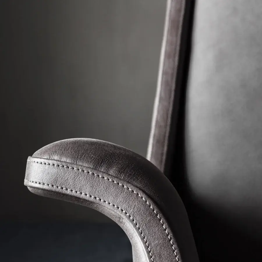 Superior OAK Blues lounge chair with curved silhouette and lavish dark gray leather upholstery built with a painted metal base