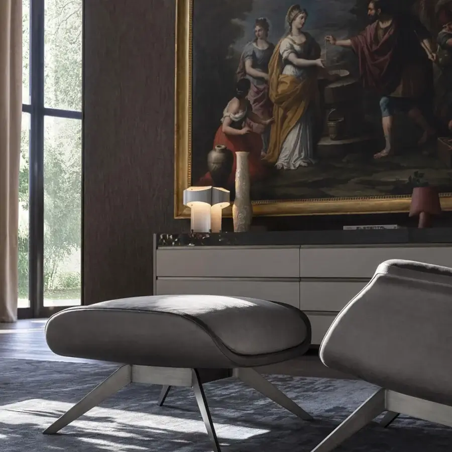 Exceptional OAK Blues lounge chair and pouf upholstered in dark gray textile with tone-on-tone stitching and matte painted metal base
