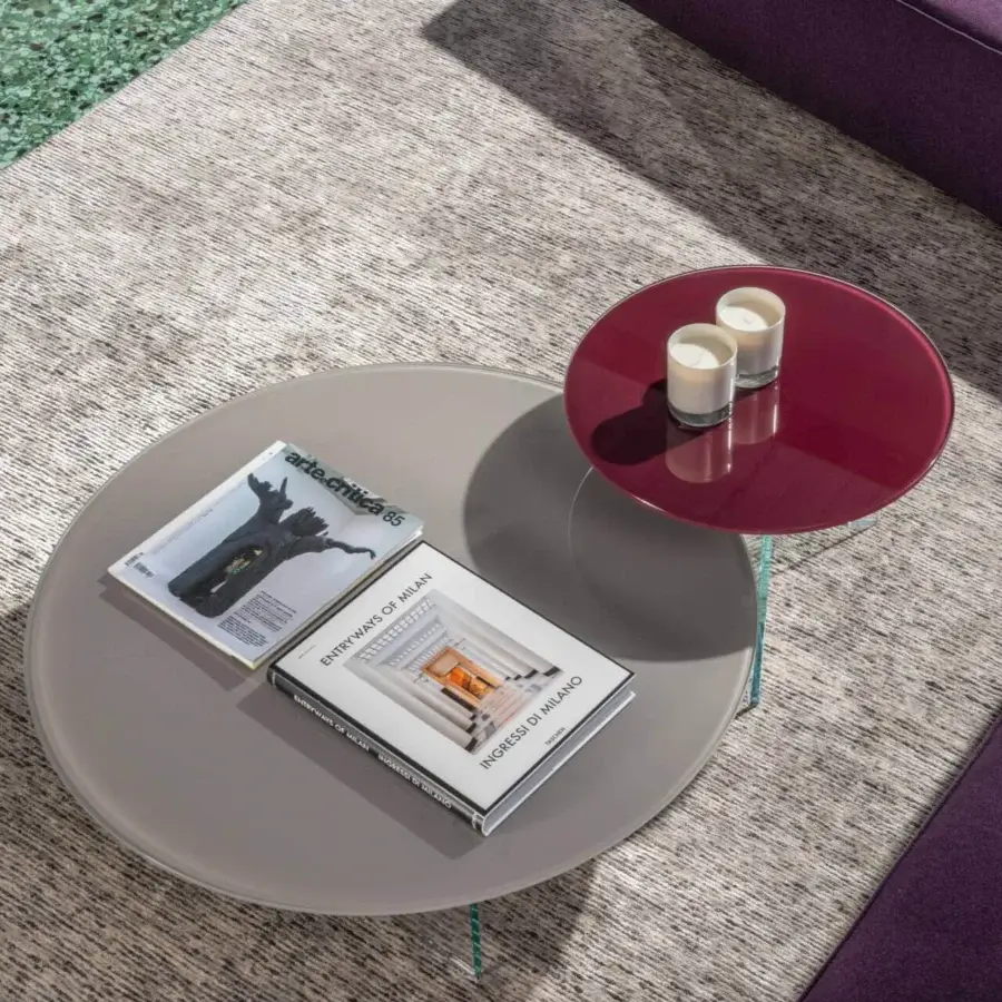 Superior Lago Air Round Coffee Table with transparent tempered glass legs and matte gray alongside glossy deep red surfaces