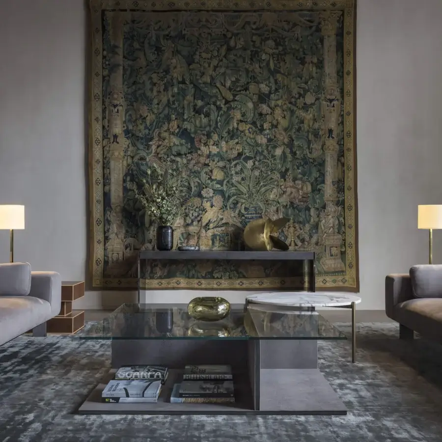 Distinguished OAK Opera sofa upholstered in muted gray textile with sleek dark metal legs and leather-covered metal carter