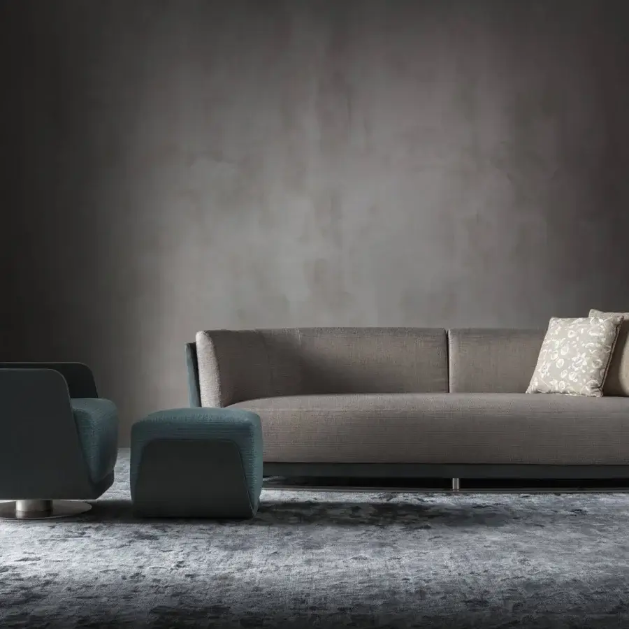 Exceptional OAK Solomon sofa with enveloping design upholstered in light brown textile and floral beige cushions with a dark-toned metal base