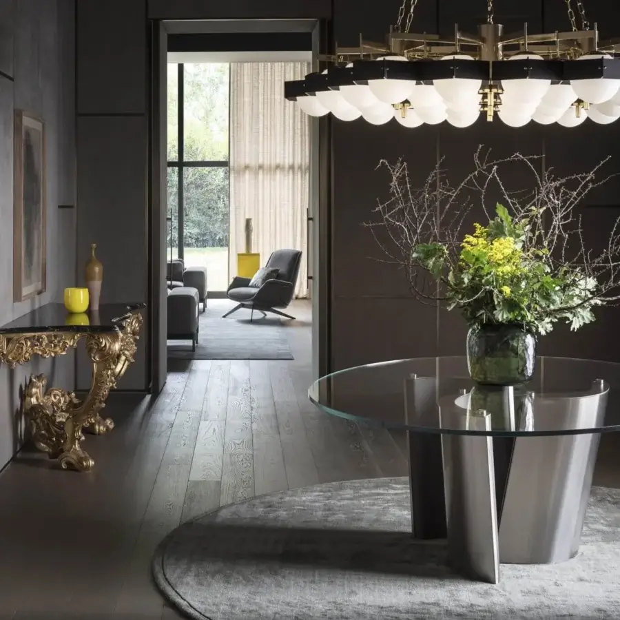 Avant-garde OAK Madison table with clear glass top and inverted V-shaped metal supports exhibiting a smooth finish