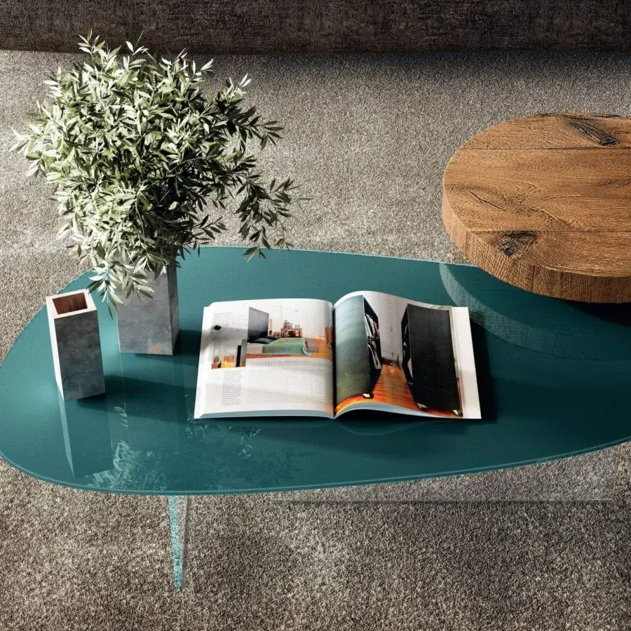 Distinguished Lago Pleasure coffee table with irregular curved forms and glossy dark teal XGlass surface built on a clear glass base