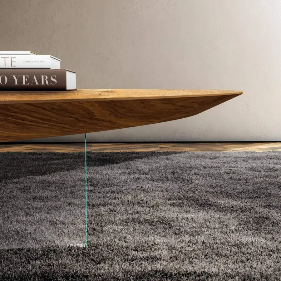 Distinguished Lago Pleasure coffee table with irregular curved forms in golden-brown wood and clear glass leg with smooth finish
