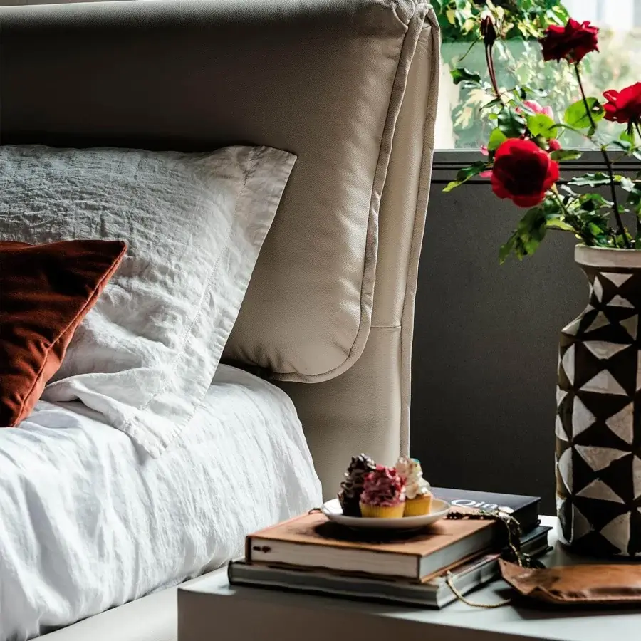 Sophisticated Cattelan Italia Adam bed upholstered in light beige soft leather with Canaletto walnut feet and orange cushion