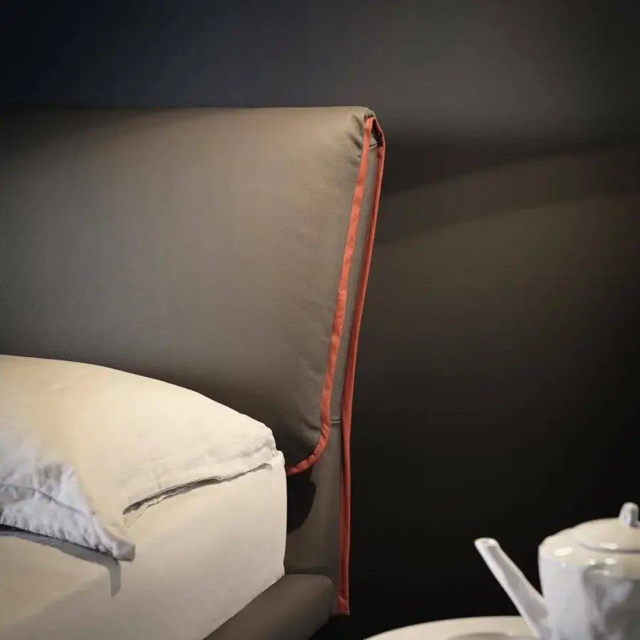 Exclusive Cattelan Italia Adam bed with substantial headboard upholstered in matte synthetic material and orange trim with Canaletto walnut feet