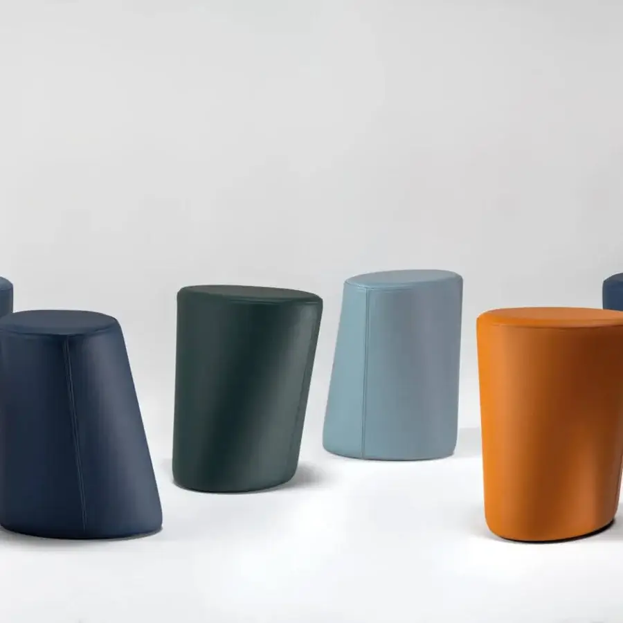 Superior Reflex Smurph ottoman crafted in vibrant forest green fabrics or leathers with cylindrical form