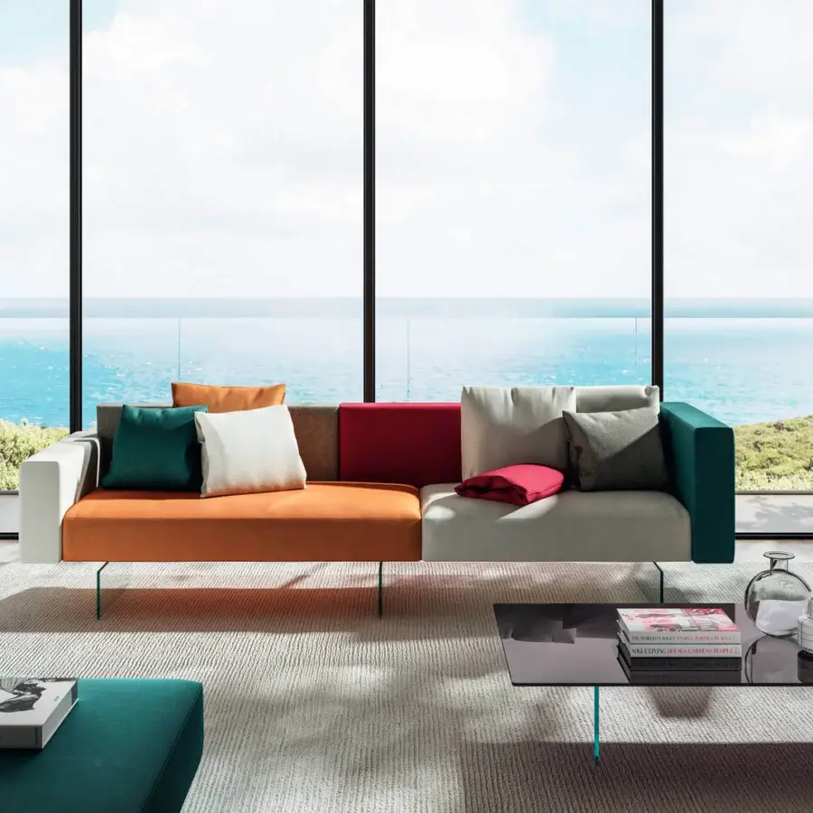 Distinguished Lago Air sofa with a modular design upholstered in orange, brown, red, white, gray and teal with extra-clear tempered glass legs