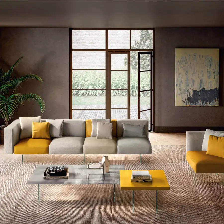 Innovative Lago Air sofa with a modular build upholstered in light gray textile alternating with mustard yellow sections and slender metal supports