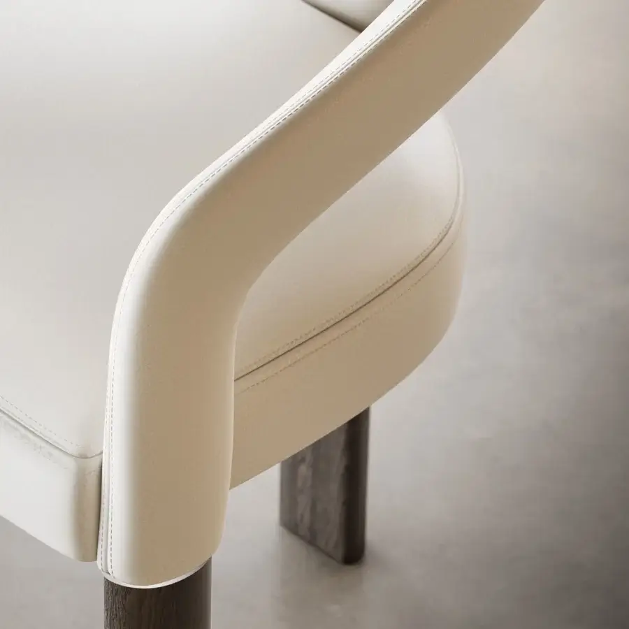 Exceptional Reflex Volta armchair upholstered in light cream material with Oakwood Henné legs and shiny steel detail