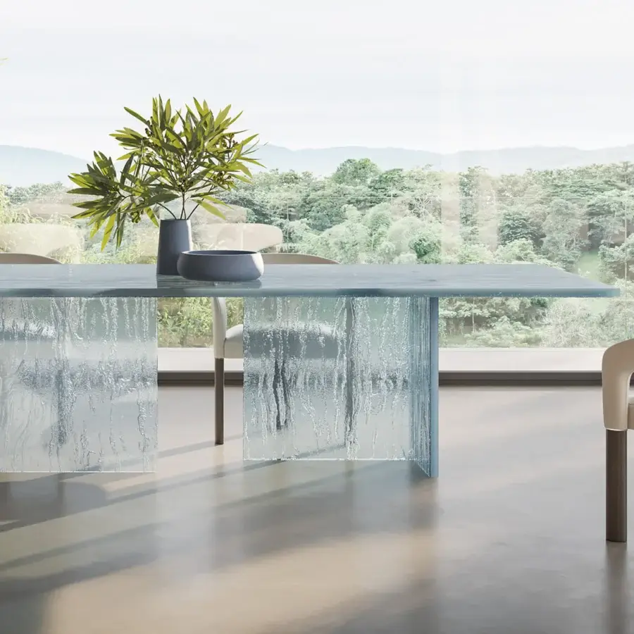 Innovative Reflex Laguna table with handmade molten glass top and textured clear glass bases creating a modern aesthetic